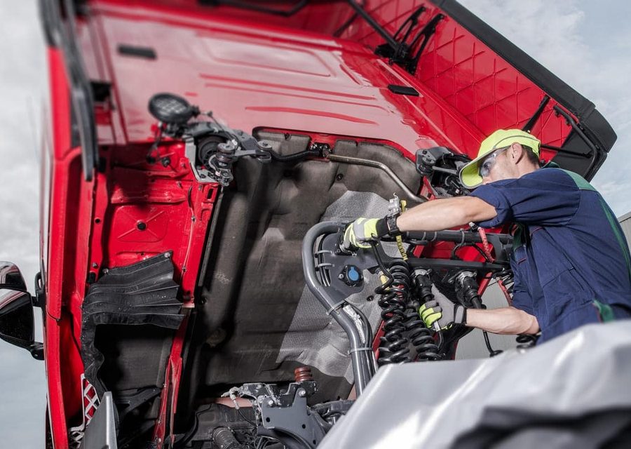 Technician servicing a heavy-duty truck in the AutoRight workshop
